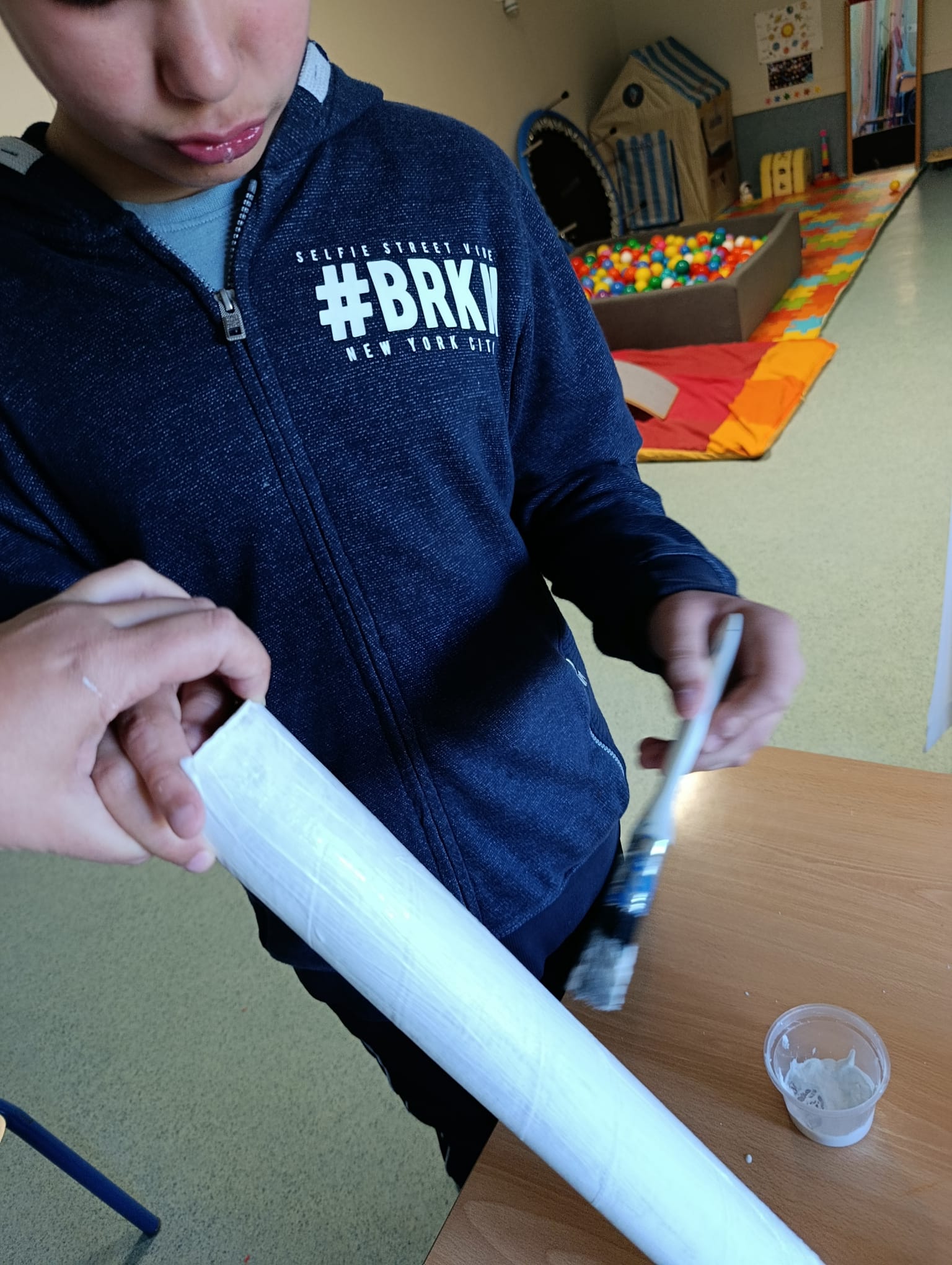 Pintura de tubos de cartão para construir os braços e pernas do depósito